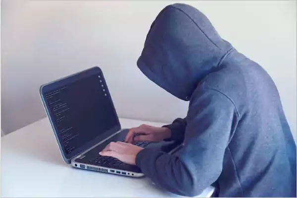 Person Entering Password in a Laptop